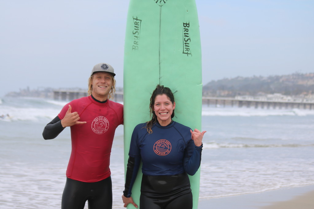 Man and woman in the surfing lesson